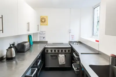 a kitchen with a stove and a counter top at Weirside, Chapel Stile in Ambleside