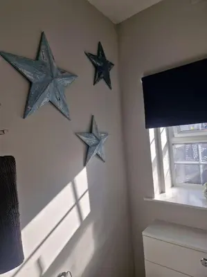 three blue stars hanging on a wall in a room at The Old Bank at St Bees, Western Lakes in St Bees