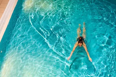 a woman laying on her back in a swimming pool at Underscar - Grange in Keswick