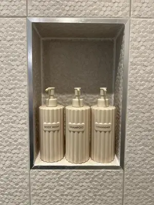 three metal cylinders in a shelf in a wall at Firth View 2 - Country Escape with Sea Views of Arran! in Ayr