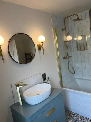 a bathroom with a sink and a mirror and a tub at Firth View 2 - Country Escape with Sea Views of Arran! in Ayr