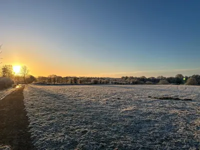 a snowy field with the sun setting in the background at wonderful 4 bedroom cottage sleeps 8 in Carlisle