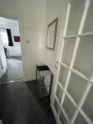 a room with a glass table and a door at DG1 1ST Floor Flat in Dumfries