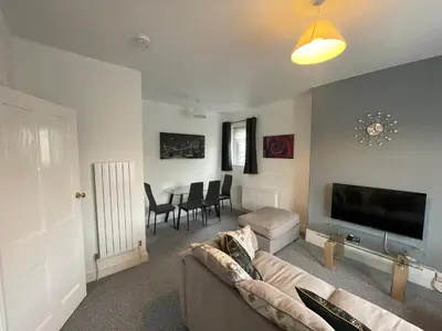 a living room with a couch and a flat screen tv at DG1 1ST Floor Flat in Dumfries