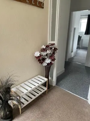 a vase of flowers sitting next to a stair case at DG1 1ST Floor Flat in Dumfries
