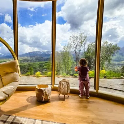 a young child standing in front of a large window at BonnieClyde in Beattock
