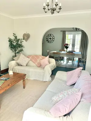 a living room with two couches and a table at Kionslieu Farm Cottages in Foxdale