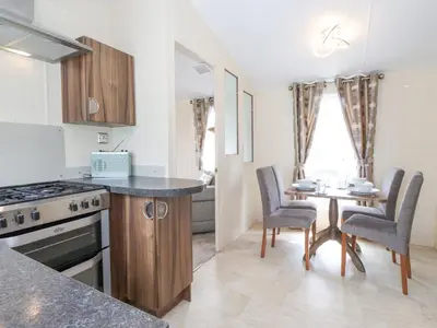 a kitchen and dining room with a table and chairs at 31 Forest Views in Cockermouth