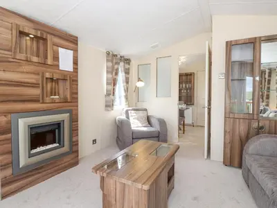 a living room with a couch and a fireplace at 31 Forest Views in Cockermouth