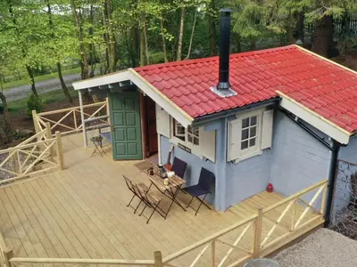 a small house with a red roof on a deck at The Signal Box in Girvan