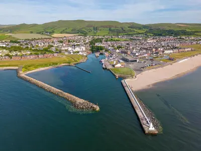 an aerial view of a beach next to a city at The Signal Box in Girvan