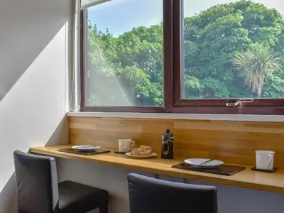 a table with a plate of food and a window at Woodlea Cottage 1 in Dippin