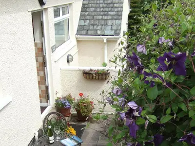 a house with flowers on the side of it at Oakvale - Oak Leaf in Braithwaite