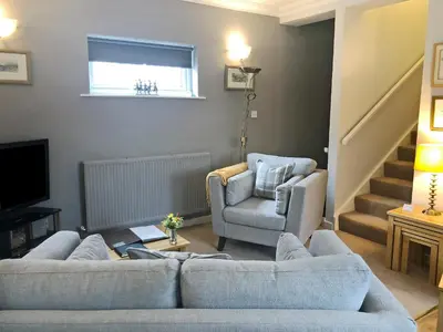 a living room with a couch and a chair at Oakvale - Oak Leaf in Braithwaite