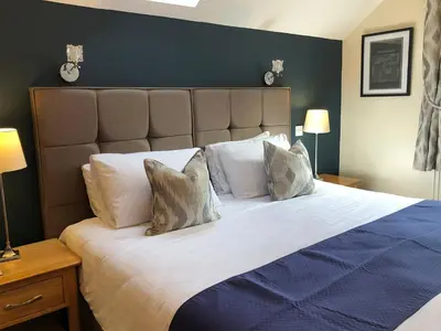 a bedroom with a large bed with white pillows at Oakvale - Oak Leaf in Braithwaite