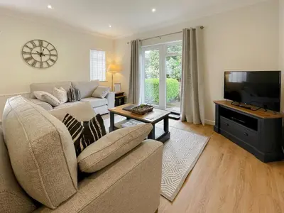 a living room with a couch and a flat screen tv at Oakvale - Acorn in Braithwaite