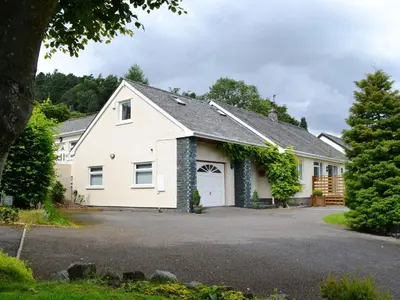a white house with a garage at Oakvale - Acorn in Braithwaite
