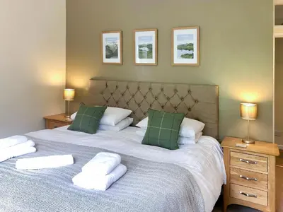 a bedroom with two beds with pillows and two lamps at Oakvale - Acorn in Braithwaite