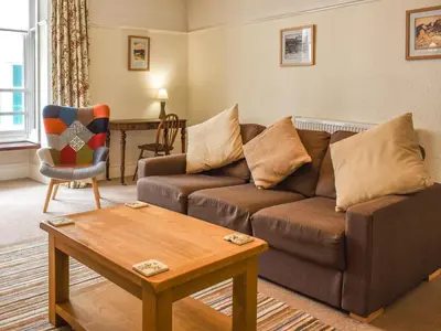 a living room with a couch and a coffee table at Cumberland Place in Keswick