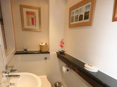 a bathroom with a toilet and a sink at Rowan Cottage in Borgue