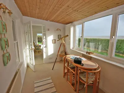a room with a desk and a table and windows at East Cottage in Mainsriddle