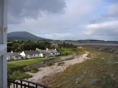 a view of a village with houses and the water at East Cottage in Mainsriddle