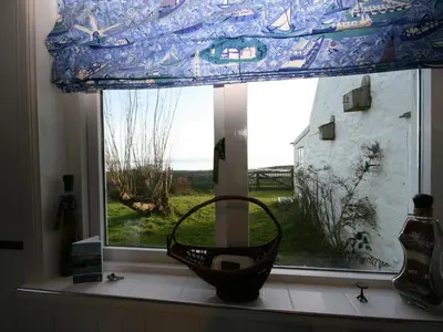 a window with a basket in a room with a view at East Cottage in Mainsriddle