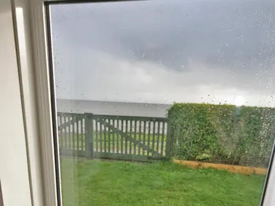 a view of the ocean from a window at East Cottage in Mainsriddle