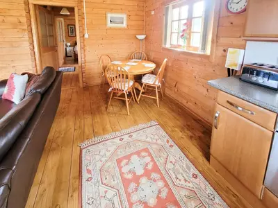 a living room with a couch and a table at Forest Lodge in Dumfries