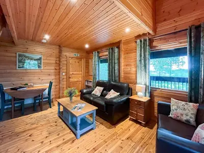 a living room with a couch and a table at Criffel Lodge in Ringford