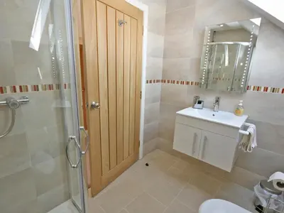 a bathroom with a toilet and a sink and a shower at Cairndoon Steading Whithorn in Carleton