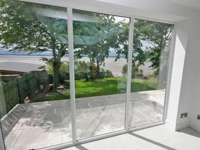 a large window in a house looking out onto a patio at Dornock Brow Cottage in Dornock