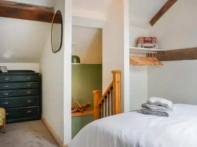 a bedroom with a bed and a dresser at Pickles Barn in Ireby