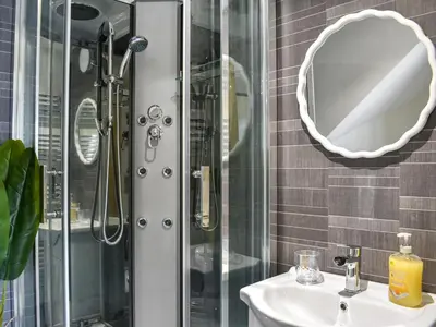 a bathroom with a shower and a sink and a mirror at Pickles Barn in Ireby