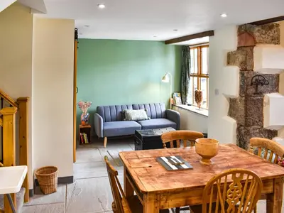 a living room with a table and a couch at Pickles Barn in Ireby
