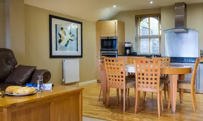 a kitchen and living room with a table and chairs at Underscar - Littledale in Keswick