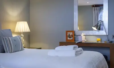 a bedroom with a bed with towels on it at Underscar - Littledale in Keswick