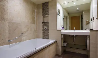 a bathroom with a tub and a sink at Underscar - Littledale in Keswick