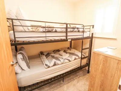 a bunk bed room with two bunk beds at Squirrel Cottage in Penrith