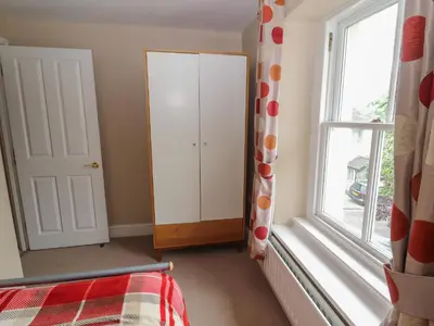 a bedroom with a bed and a window at Lillibet Cottage in Keswick