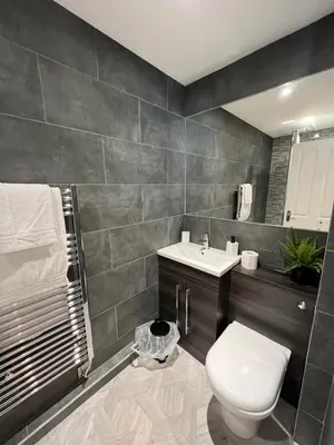 a bathroom with a toilet and a sink at The Globe Apartments and Bedrooms in Cockermouth