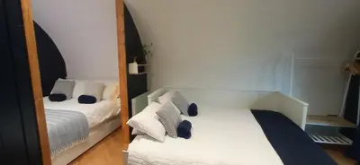 a bedroom with two beds and a mirror at little peru luxury pods and alpaca farm in Crosshill