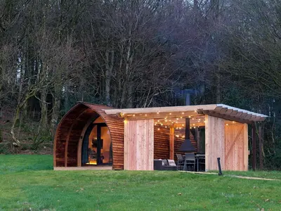 a small wooden house in a field of grass at Glencartholm Farm by Wigwam Holidays in Canonbie