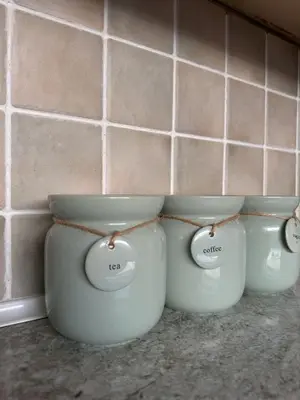 four white pots sitting on a counter in a kitchen at Bolton Terrace - 2 Bedrooms - Sleeps 4 in Workington