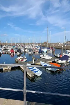a bunch of boats are docked in a marina at Harbour View - 1 Bedroom - Sleeps 2 in Whitehaven