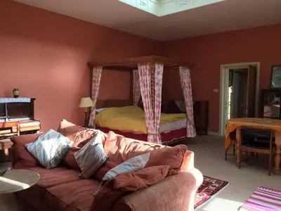 a living room with a couch and a bed at Gilchristland Organic Farm Retreat in Closeburn