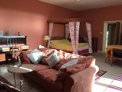 a living room with a couch and a bed at Gilchristland Organic Farm Retreat in Closeburn