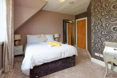 a bedroom with a bed and a sink in it at Brig o Doon 2 in Ayr