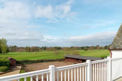 a white fence with a view of a golf course at Brig o Doon 2 in Ayr