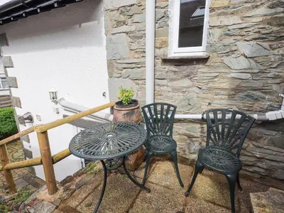 a table and two chairs on a patio at Hollens Cottage in Ambleside